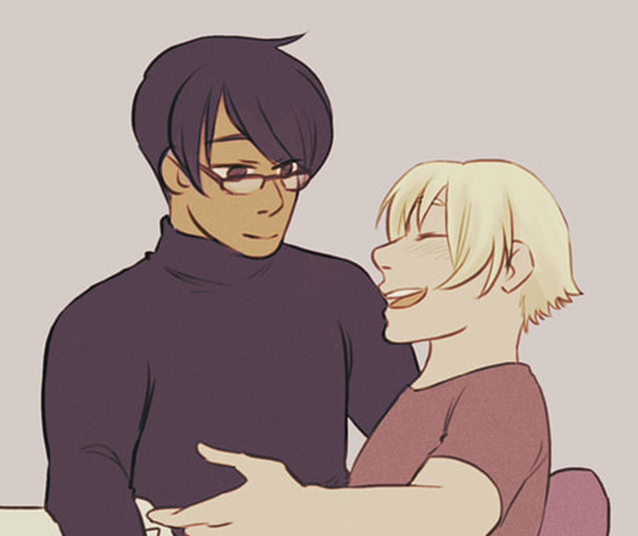 a blonde man smiling up at a man with dark hair and glasses. You can't really tell because it's cropped, but he's sitting in his lap.