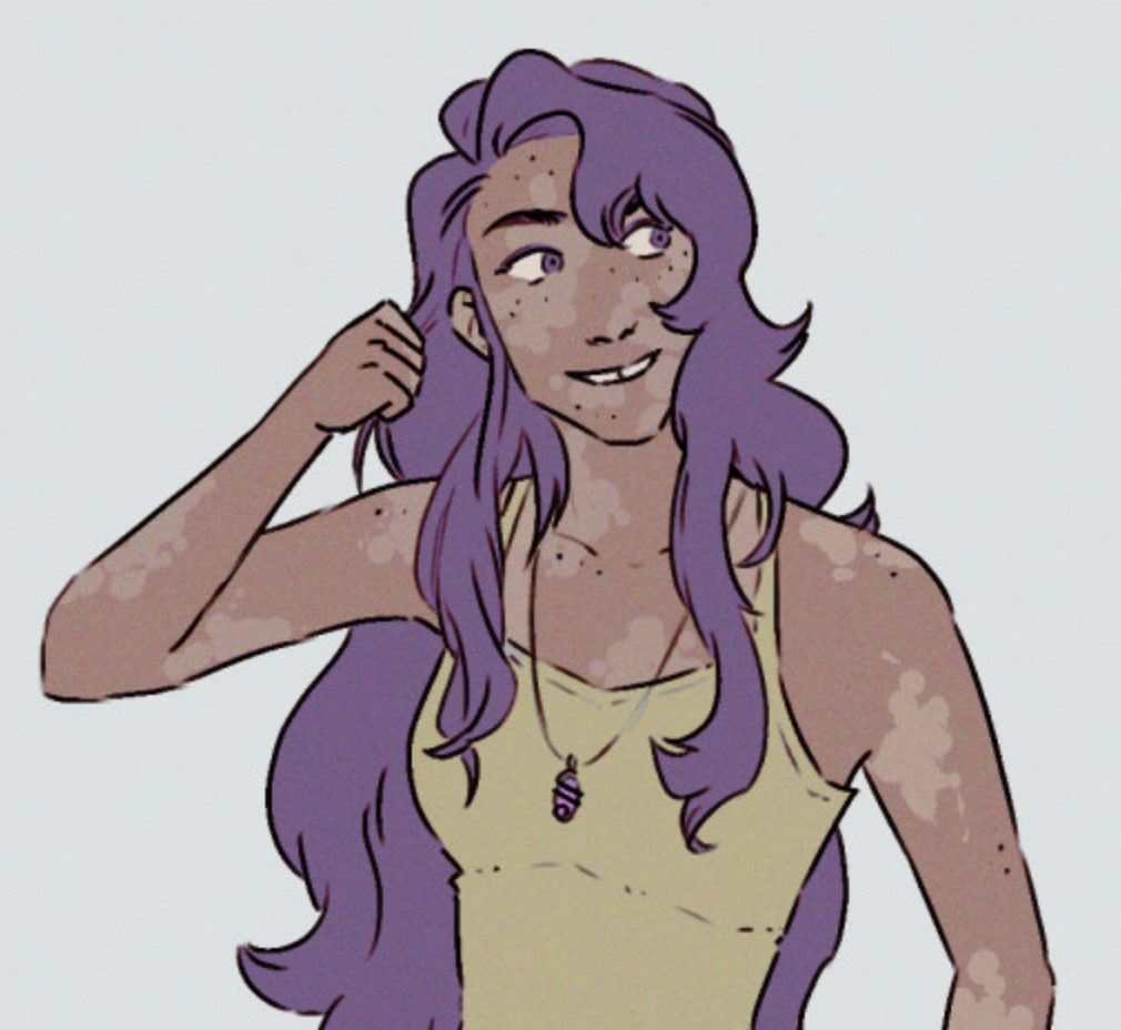 a woman with long hair and vitiligo smiling.